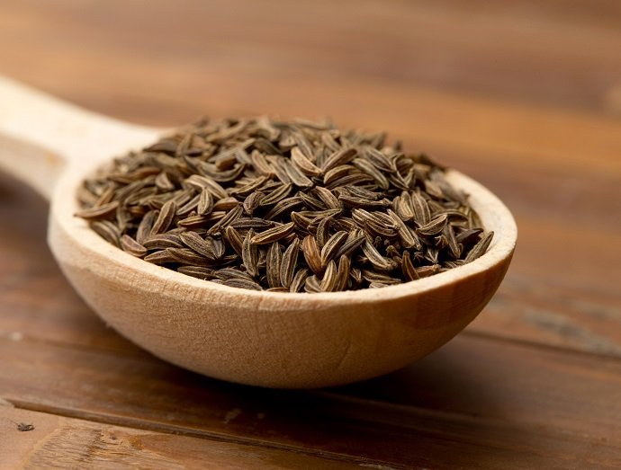 cumin seeds in a wooden spoon