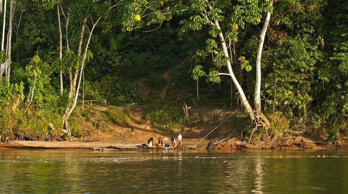 Unidentified local indigenous people next to Napo river in the rainforest, Yasuni National Park, Ecuador